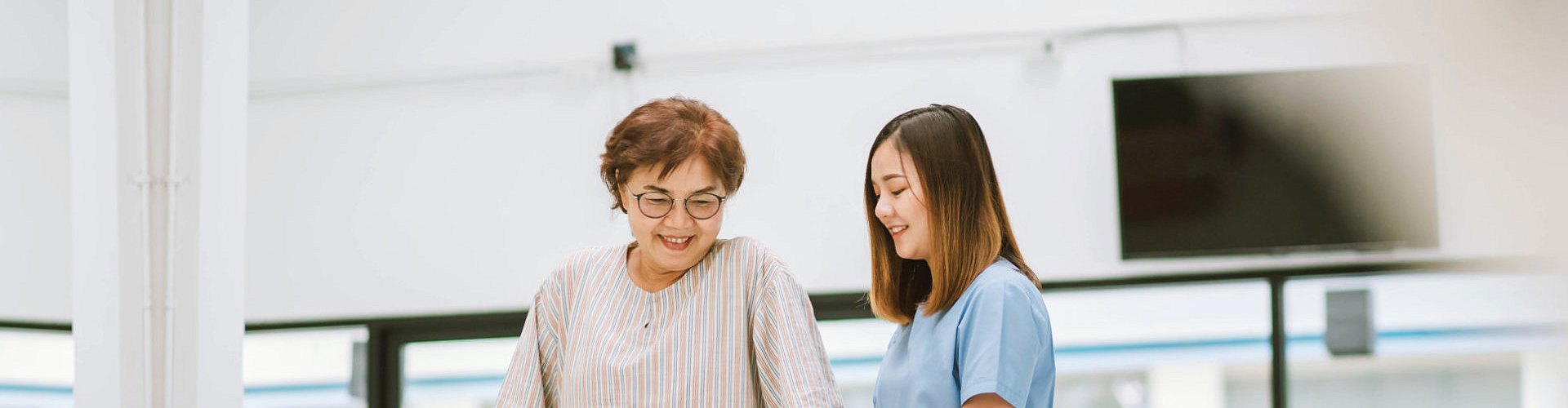 caregiver assisting to her patient to walk